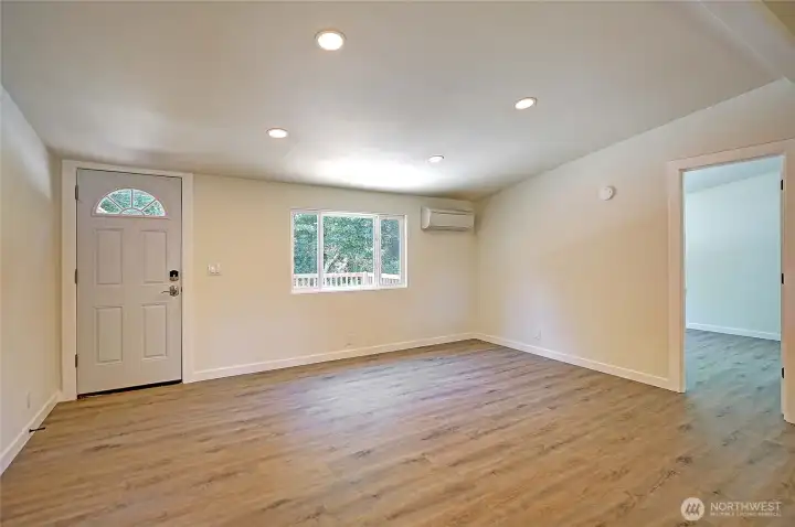 Open living area with updated flooring and mini-split comfort.