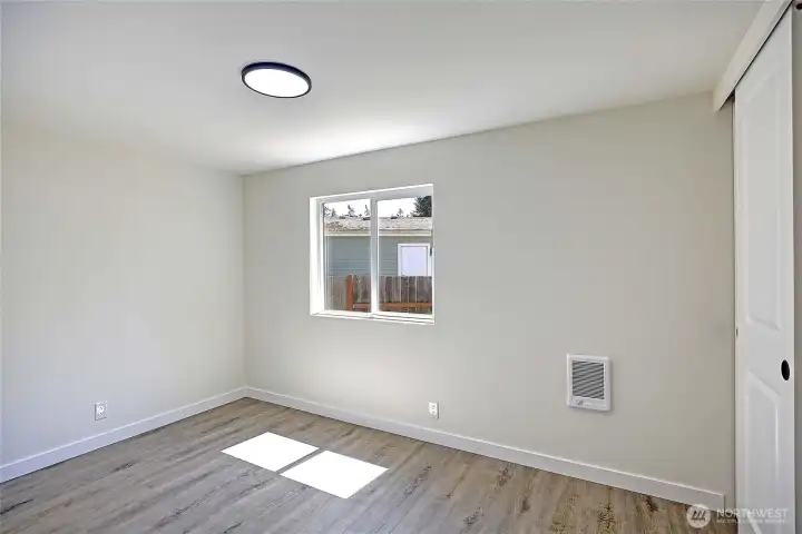 Comfortable guest bedroom with closet.