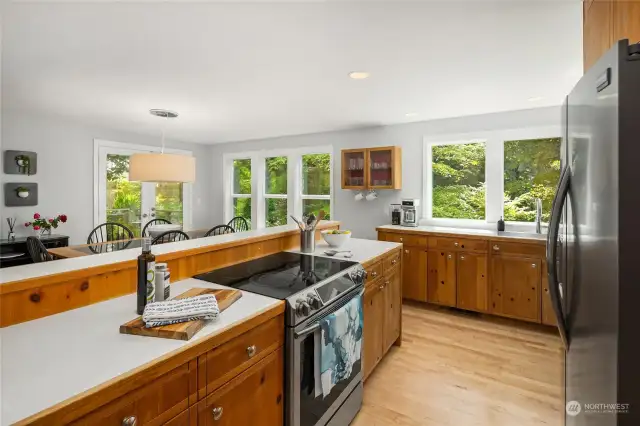 Inviting kitchen with ample windows and open to dining room