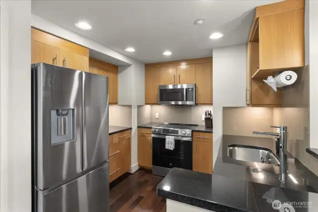 This updated and functional kitchen boasts fresh hardwood flooring, brand new appliance packages, and stunning quartz counters. It's a perfect blend of style and practicality, ready to inspire your culinary adventures.