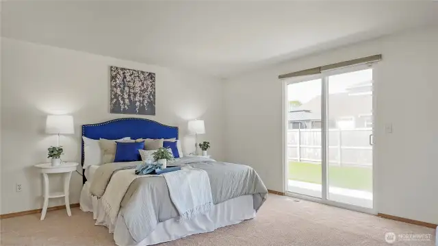 Spacious Primary Bedroom w/ Sliding Glass Door To Backyard. En-Suite and WIC To The Left