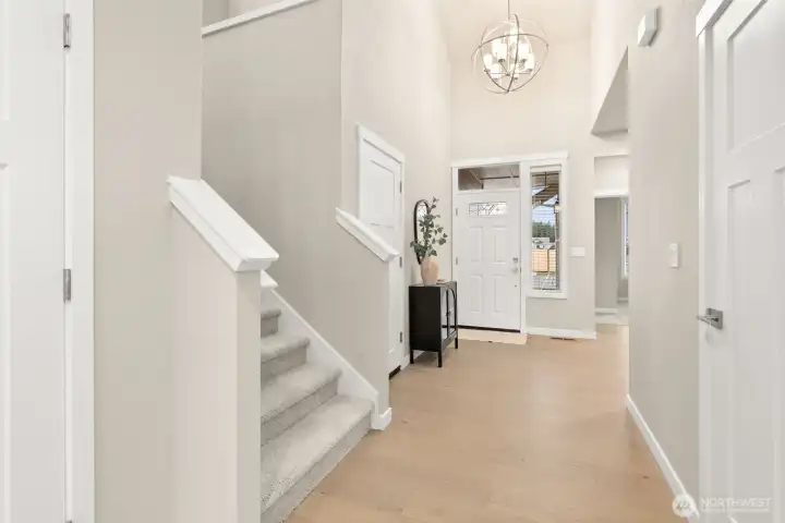 Entryway looking back at entry door with decorative glass panels that allow natural light to shine through!