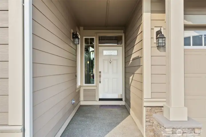 Our Spruce plan has the perfect covered porch entry to greet you and your guests with stone accents panels.