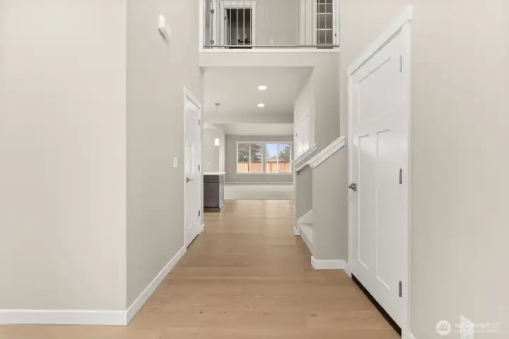 This inviting home interior showcases hardwood flooring, contemporary details and white millwork throughout.