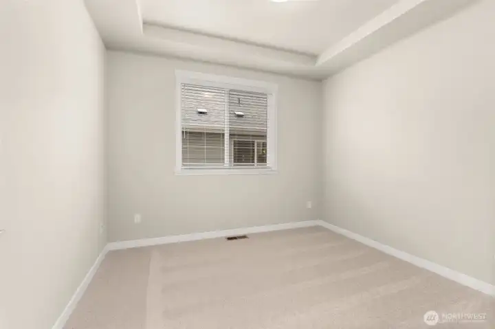 Den/ office or 3rd bed option on main level with tray ceilings and big window. It can also be used as a 3rd bed option.