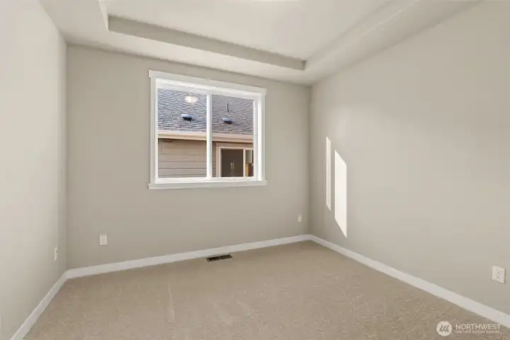 Den/ office or 3rd bed option on main level with tray ceilings and big window. It can also be used as a 3rd bed option.