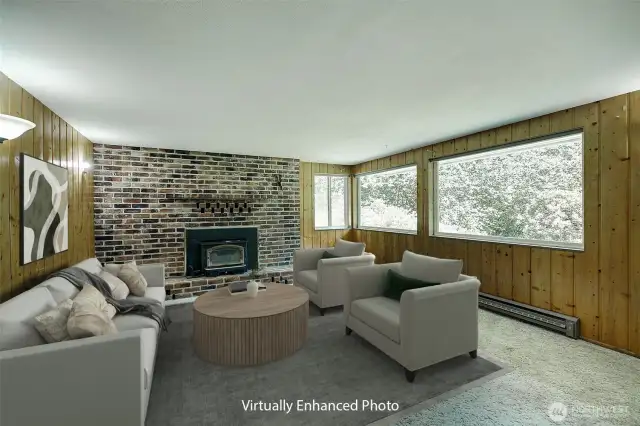 The lower level fireplace includes a wood burning fireplace insert.  Big picture windows offer views of the backyard landscape.