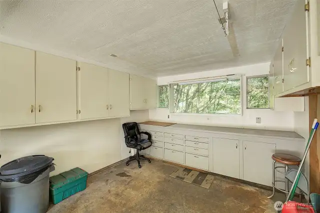The 3rd garage bay is set up as a shop with built in work bench and storage cabinets.
