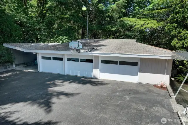 There is also a 3-car garage with 1 bay set up as a workshop with work bench, cabinets and storage; 2 traditional car bays, plus there’s an additional carport/storage area – wow!