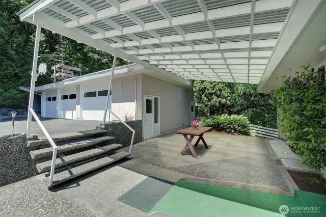 The covered patio is a segue between the house and garage.