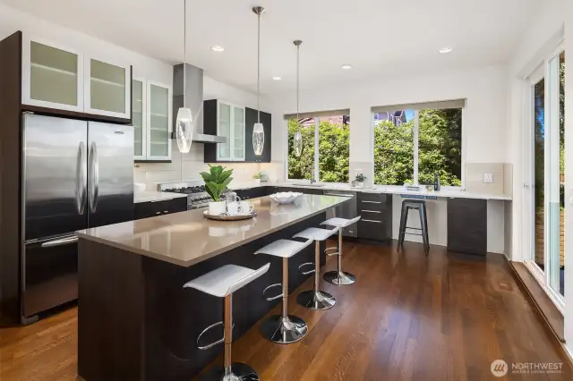 Spacious kitchen with oversized island and additional barstool seating.