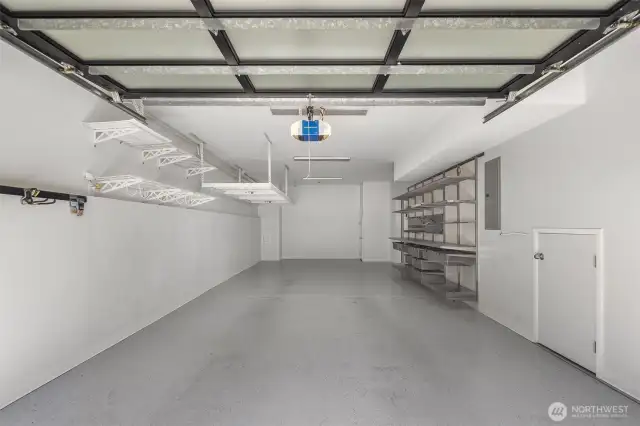 Two-car tandem garage with custom flooring & storage.