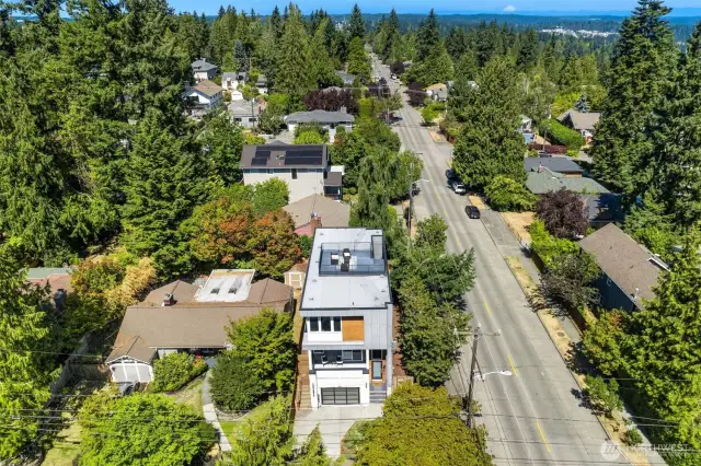 Aerial view of home showcasing rooftop deck.