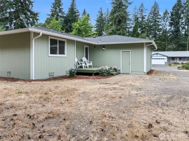 Spacious, nearly half-acre flat lot with room for RV parking, gardening, and entertaining around the fire pit.