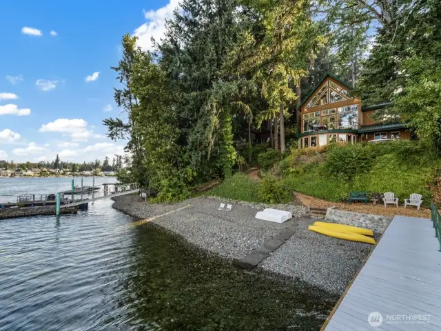 87’ of pebble beach lakefront, with pier and dock for multiple boats.