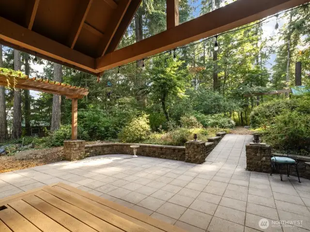 Large, covered rear porch looking out towards backyard and amazing play structure and potting shed.