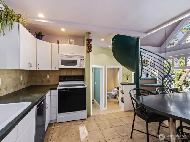 Spiral staircase leads up to loft and access to rooftop deck.