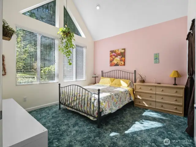 1 of 2 secondary bedrooms. This one offers vaulted ceilings.