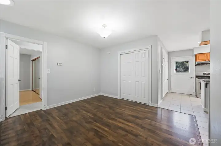 Top of entry, this is the formal dining room area. Door to hallway (open @ left); door to entertainment deck (with window @ right). Spacious storage closet at center.