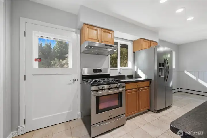 Back door leads to deck. All of the stainless appliances stay with the home making it move-in ready for you!