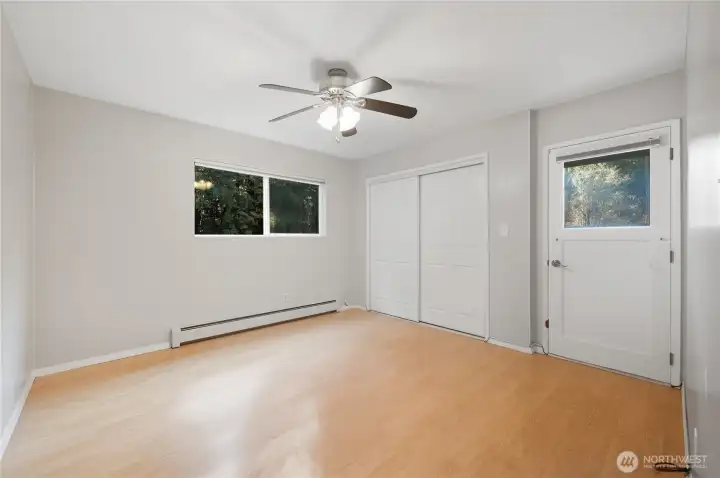 One of two bedrooms on main level. Exterior door leads to deck.