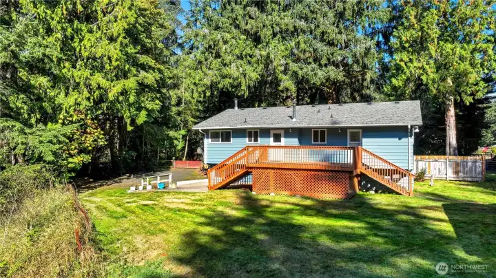 Back of home. Plenty of space to entertain, play, or just relax on the deck and yard