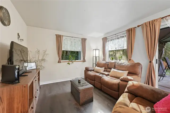 Living room space in the ADU. Sliding doors at right edge of photo lead to its covered deck/porch area.