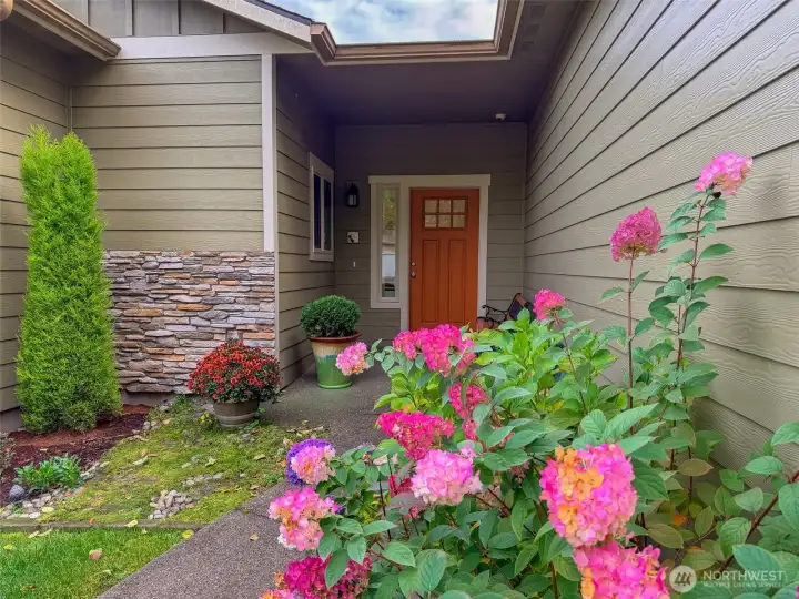 Pretty plantings along the paved pathway to the front door.