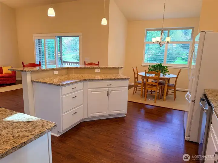 Large island with eating bar, counter and cabinetry.