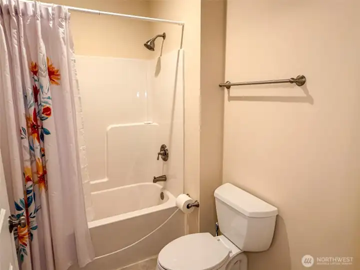 Favorably placed full bath near great room and front entry.