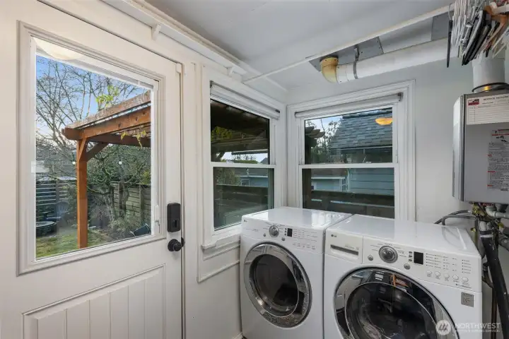 The laundry room is off the kitchen and accesses the backyard