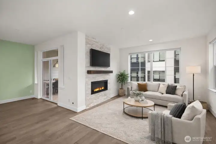 A wall of windows floods the great room with natural light while the fireplace provides warmth.