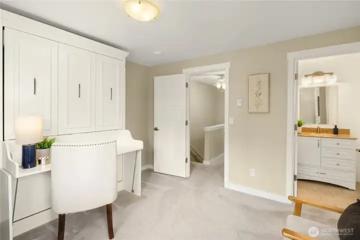 This versatile second primary bedroom is a space-saver's dream, featuring a high-end Murphy bed and integrated desk—perfect for a home office that doubles as a guest suite.