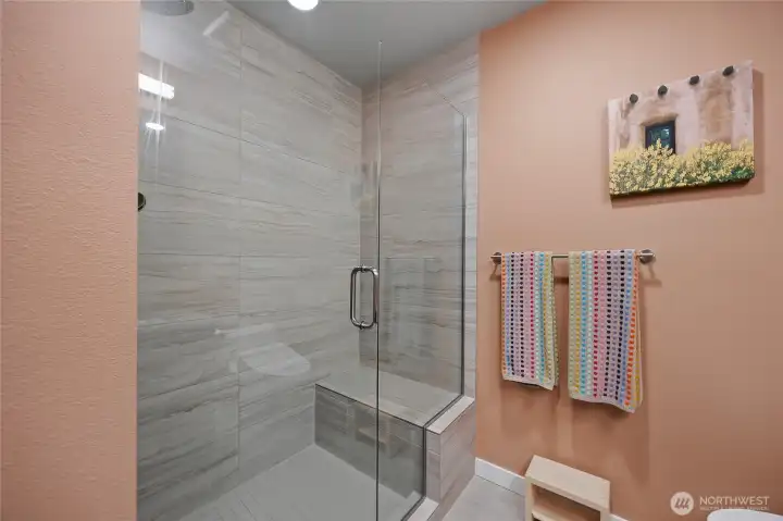 Floor to ceiling tiled shower with built-in bench. Floor to ceiling tiled shower with built-in bench.
