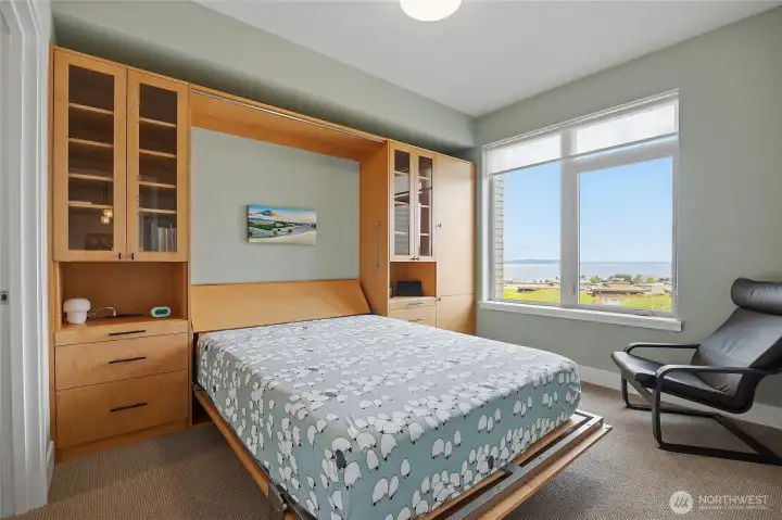 This secondary bedroom has a custom wall bed that saves space and gives options for guests. This secondary bedroom has a custom wall bed that saves space and gives options for guests.