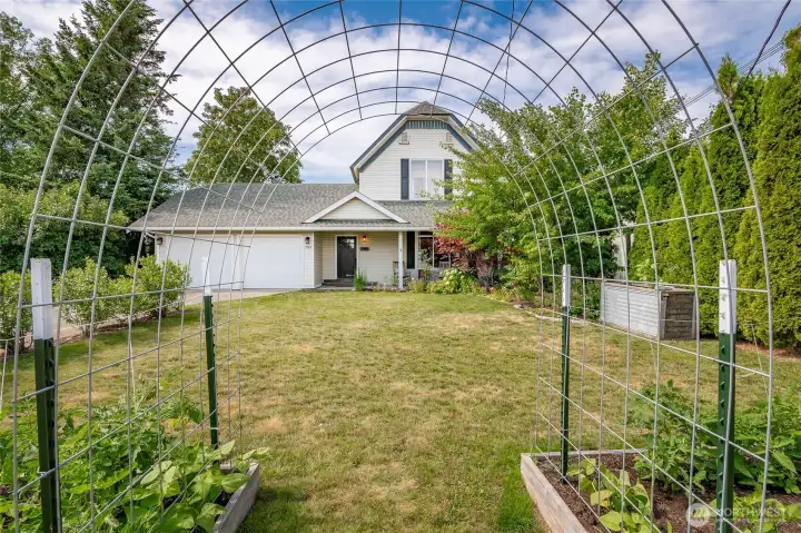 Well-utilized yard space throughout including ample garden beds, blueberry bushes, fruit trees, greenhouse & more!