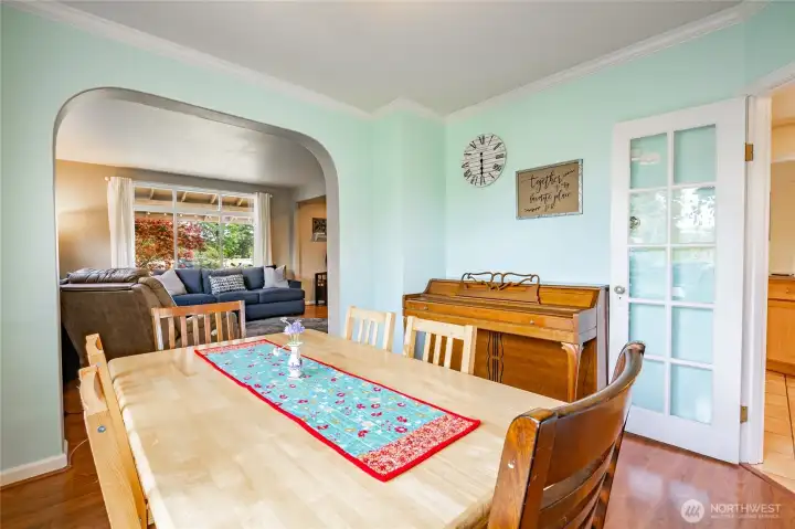 Love all of the character and charm in this dining room. Archway, crown, built-in, french doors