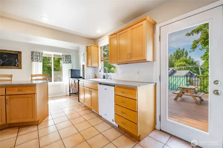 Sink overlooks back deck and yard