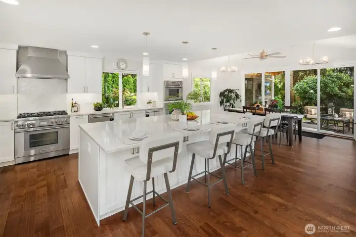 As you walk through the entrance of the home and into the Great Room - this is the view to fall for, looking toward the kitchen, dining room and out to the covered patio.