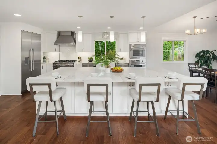 This giant-slab quartz island is approx 11 feet long and 5.5 feet wide. In addition to drawers & pullouts on the kitchen sink side of the island, there are also 4 double cabinets behind the bar stools with pull out drawers for plenty of storage. And built in Outlets