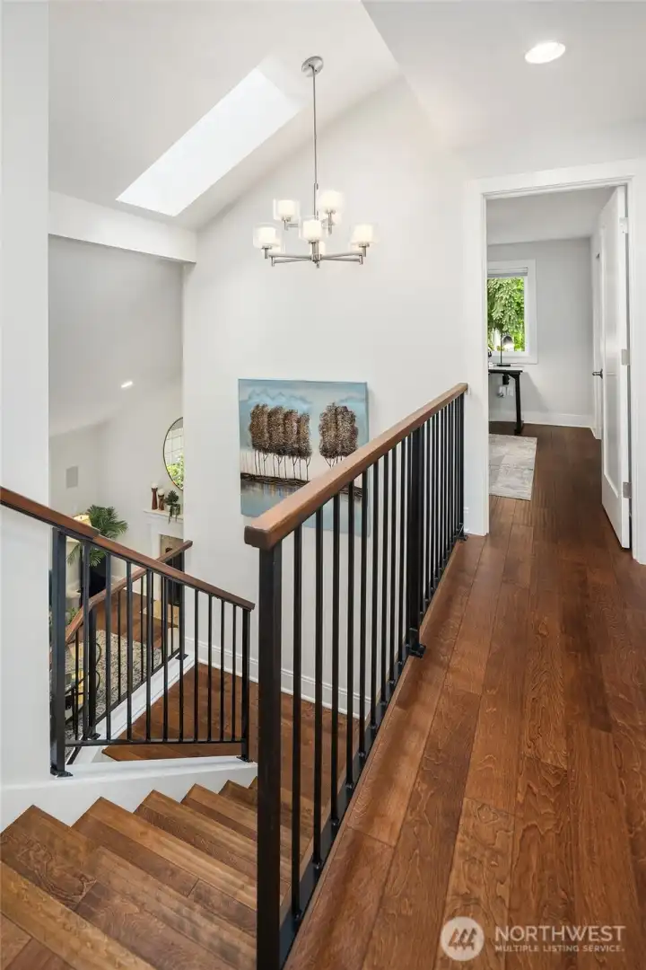 The stair way to the 2nd level looks down on the living room.