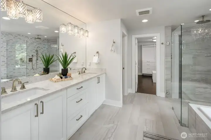 The Primary Bathroom has Heated tile floors, Quartz counters with double under mounted sinks.  A 7' soaking tub,  A large shower with 2 sources of wanter -Rain head and Wand conrol.  There is a bulit-in bench and hidden shelves for your shower products.