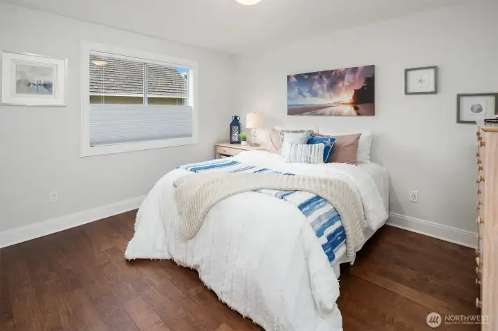 Bedroom #2 has Hardwood floors, a Wood Wrapped Window, double ceiling lights and top ewon/bottom up black out shade.  You will have plenty of room for all your clothes - the closet is approx 9 feet long!