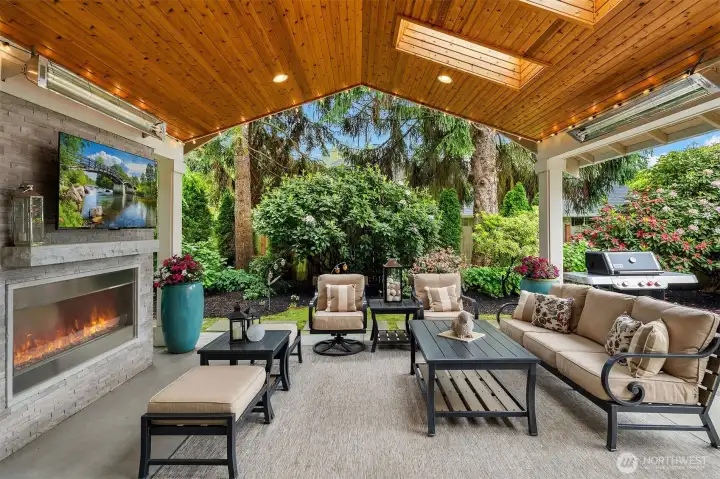 Thsi covered outdoor room features:  Knotty Pine Vaulted ceiling with can lights, 3 skylights, 2 heaters, a gas fireplace with color change and natural stone base with a tv above the mantel.  There is a wire system that is hung to accomodate the clear drapes that can be installed for winder to make this room trully usable year around.