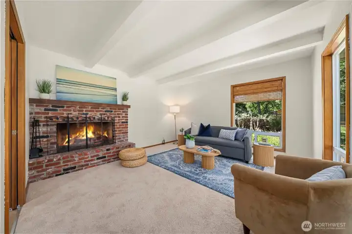 Bright and inviting living room with fireplace.