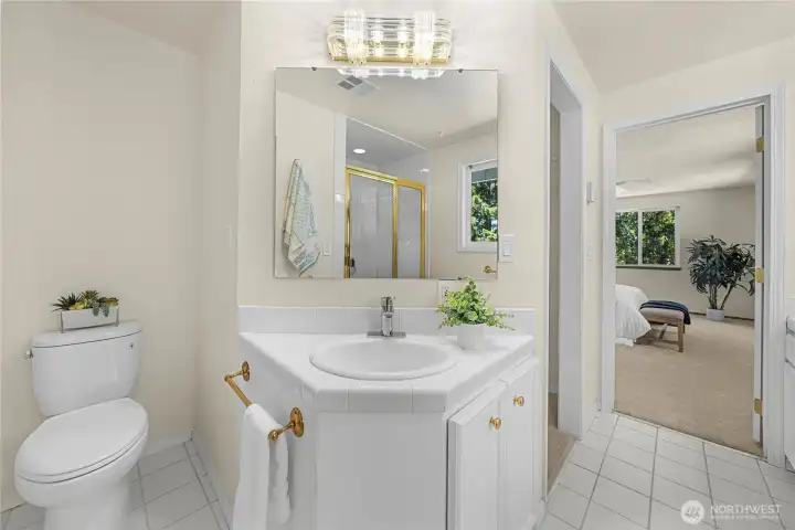 Primary suite bathroom featuring dual vanities (one to the right, not pictured), providing plenty of personal space and convenience for busy mornings.