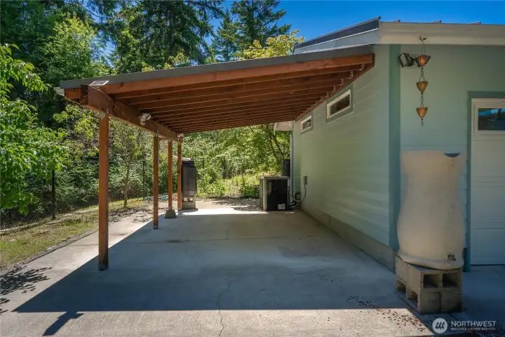 Carport ideal for additional vehicles or toys.