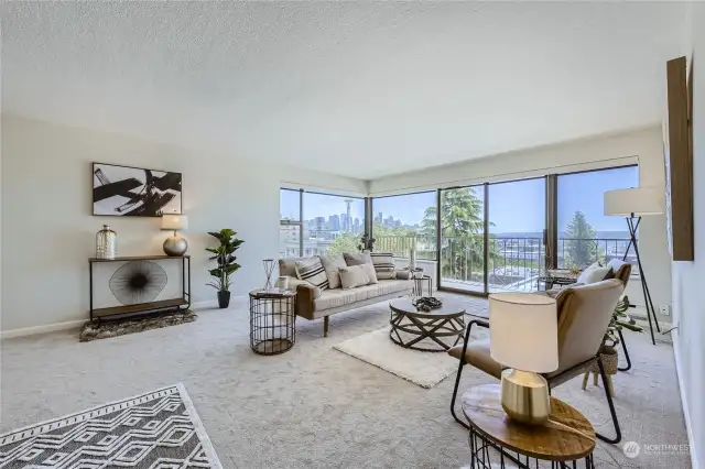 View from when you enter the unit. Large living room with new carpet and views of space needle, city, mountains and water
