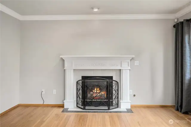 Gas-log fireplace enhanced by the wood mantel and fluted molded wood surround. In-laid tile hearth. Note the wood crown molding on the main level.