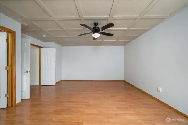 Spacious Primary bedroom with fan and ceiling lattice-work artistically designed for this room. Double door entry.